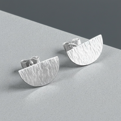 Hammered semicircle sterling silver stud earrings.