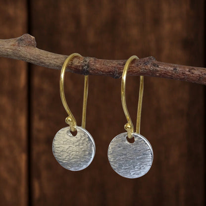 Hammered sterling silver disc and gold vermeil ear wire earrings.