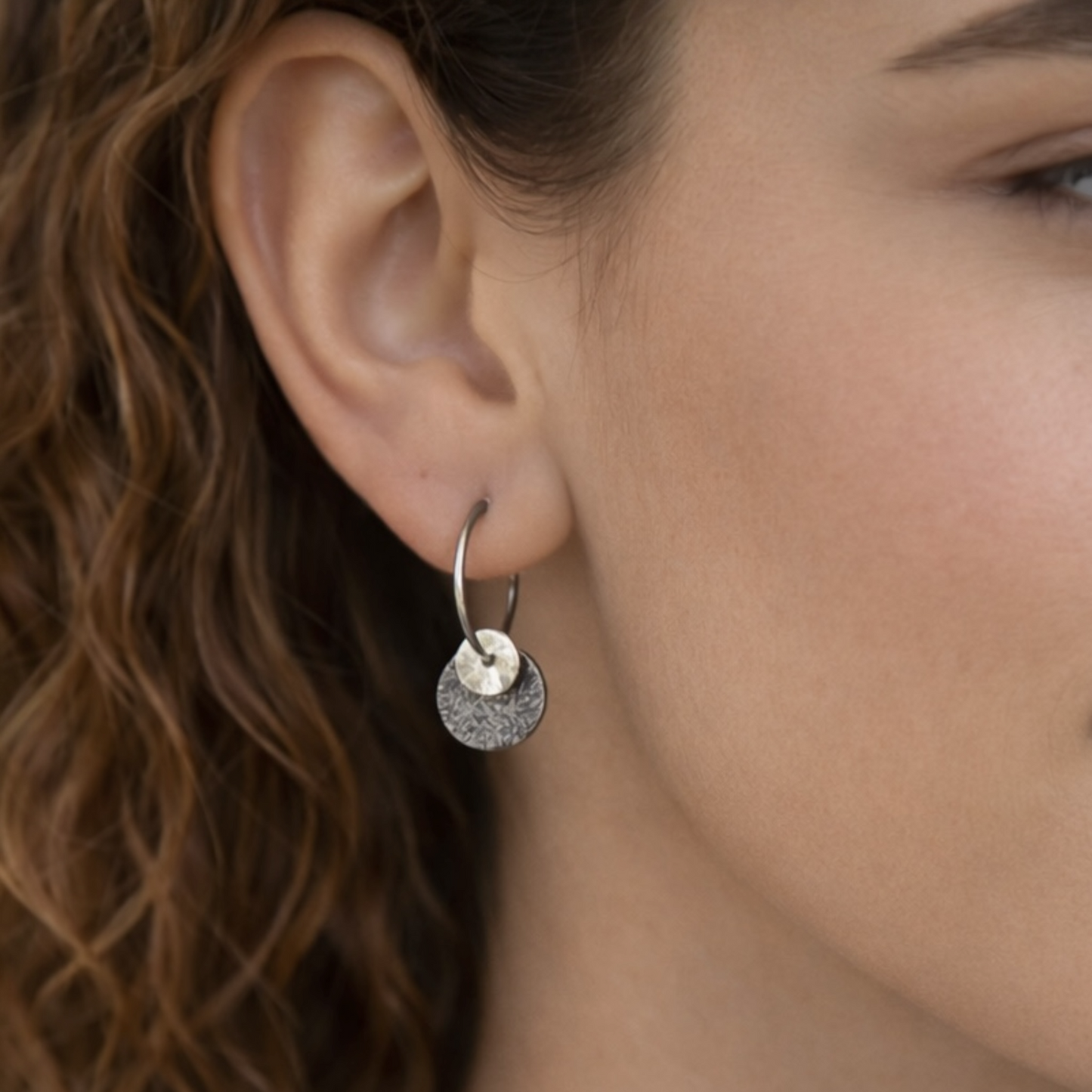 Sterling silver oxidised hammered disc hoop earrings.