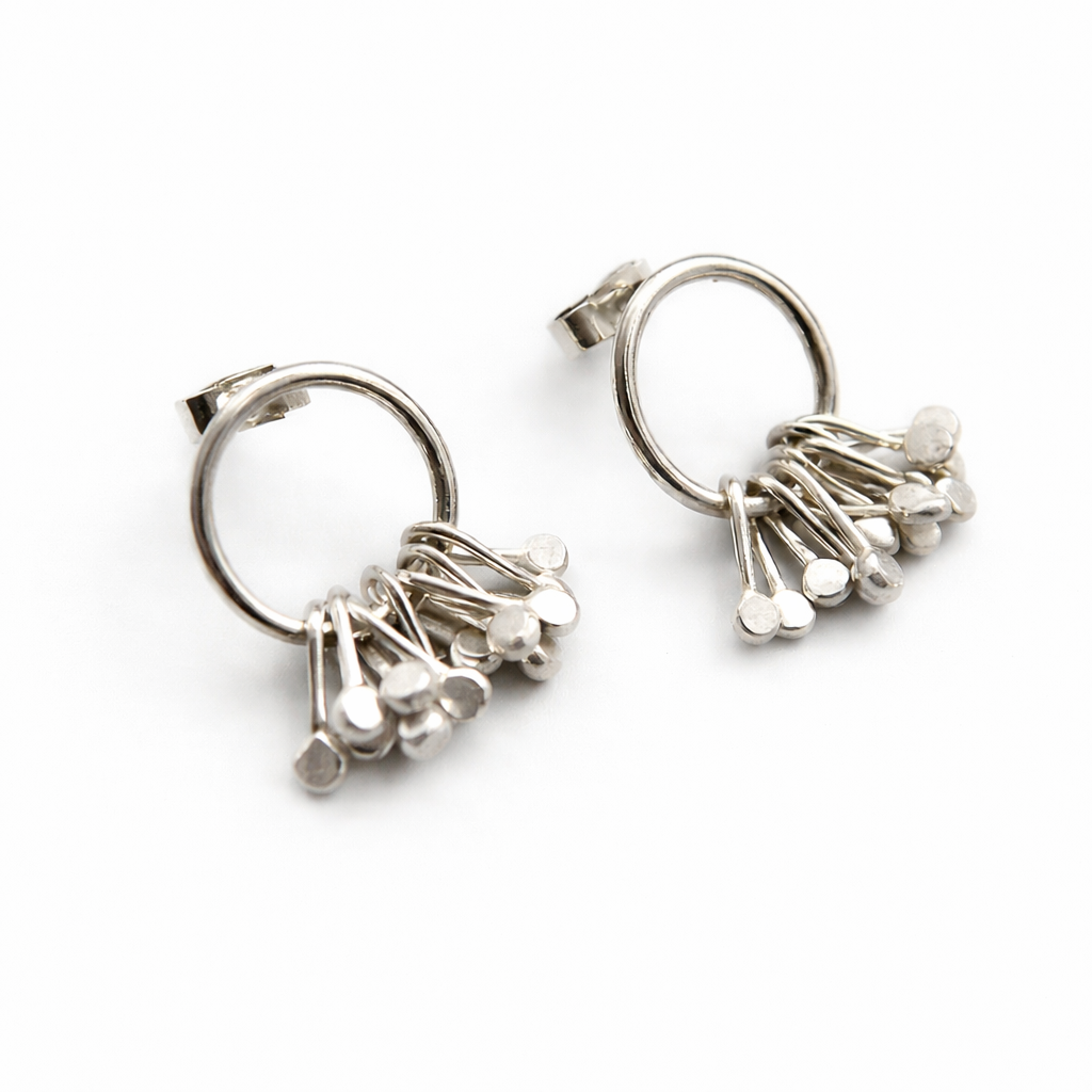 Sterling silver circle and droplets stud earrings.