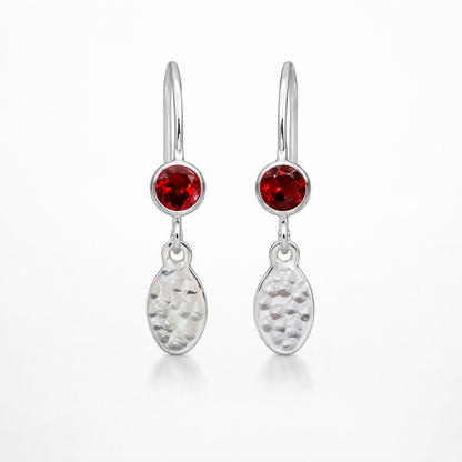 Garnet birthstone sterling silver dangle textured oval earrings.