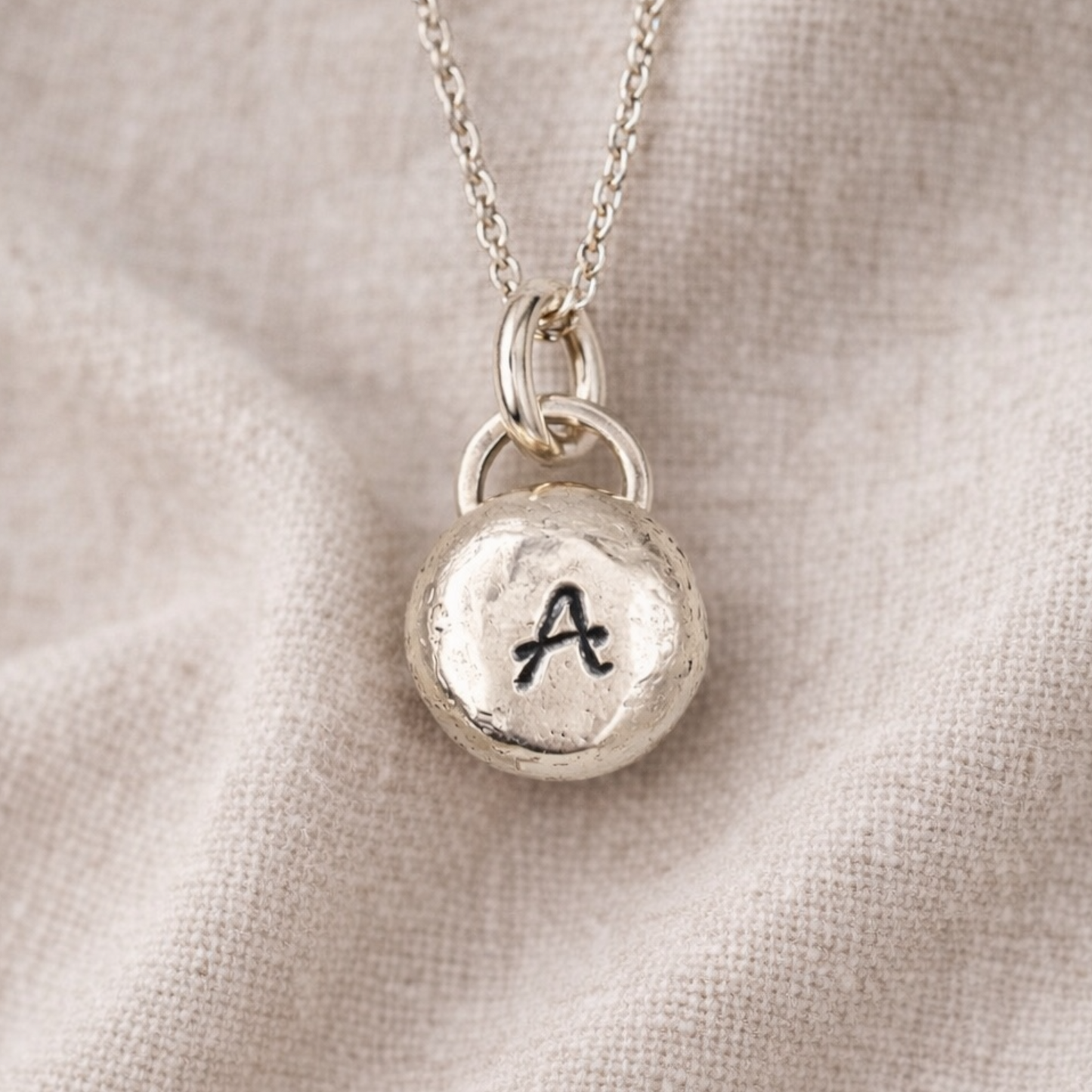 Pebble solid sterling silver personalised letter necklace.