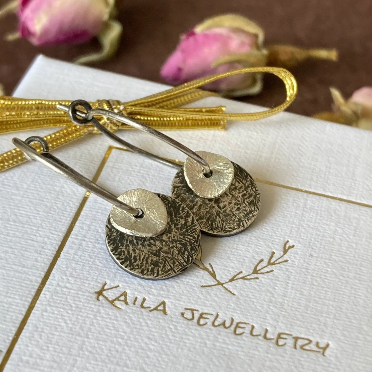 Sterling silver oxidised hammered disc hoop earrings.