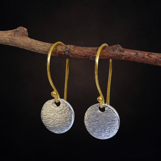 Hammered sterling silver disc and gold vermeil ear wire earrings.
