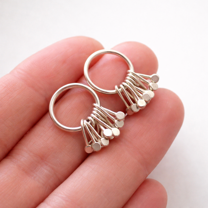 Sterling silver circle and droplets stud earrings.