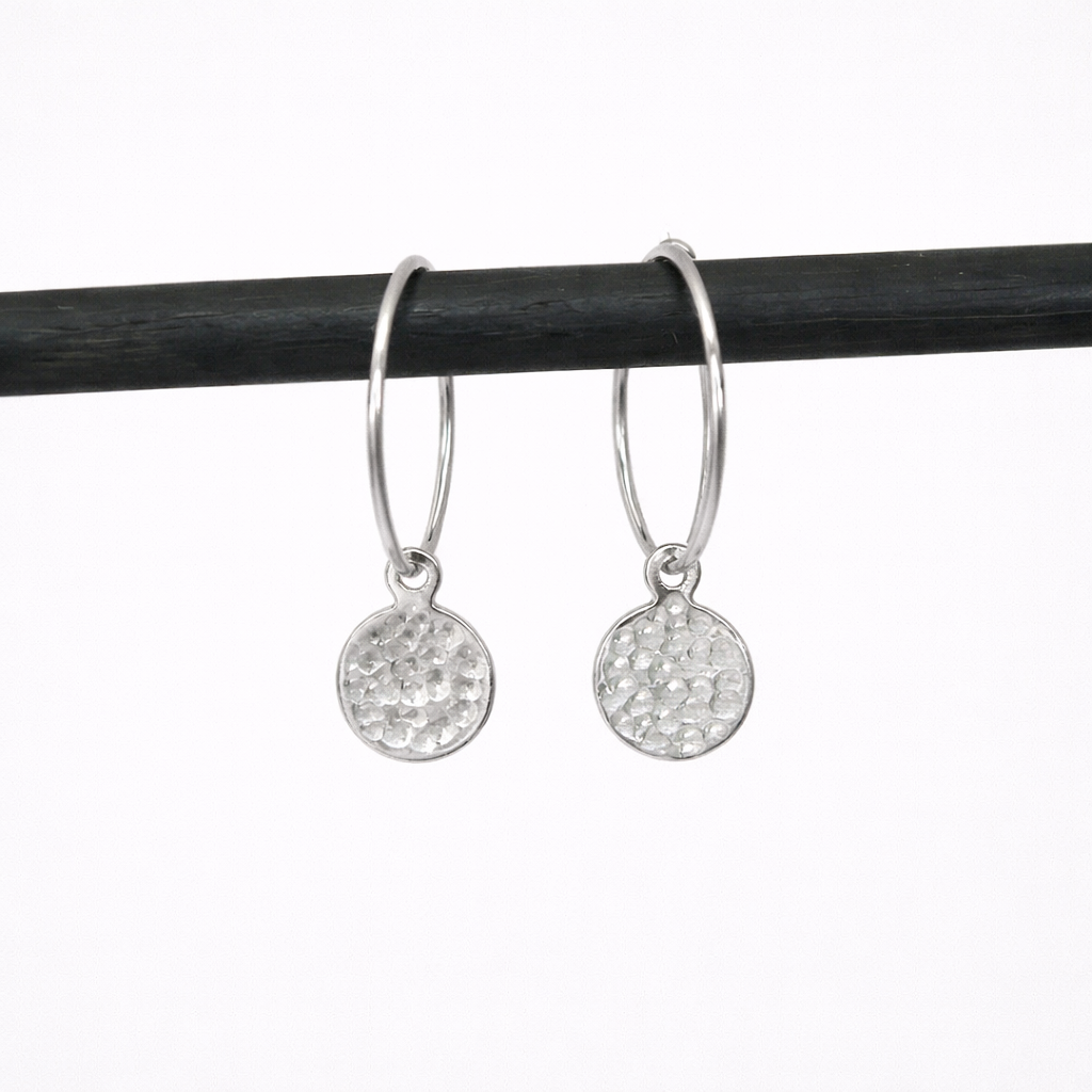 Hammered sterling silver disc charm hoop earrings.