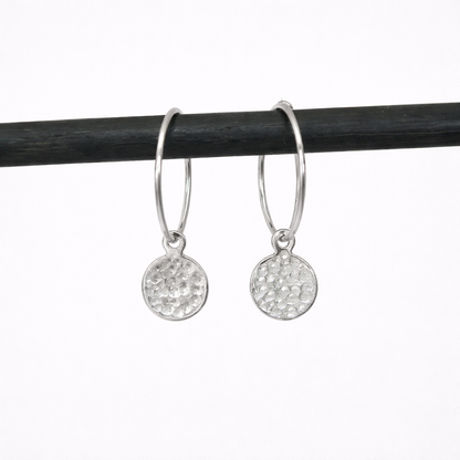 Hammered sterling silver disc charm hoop earrings.