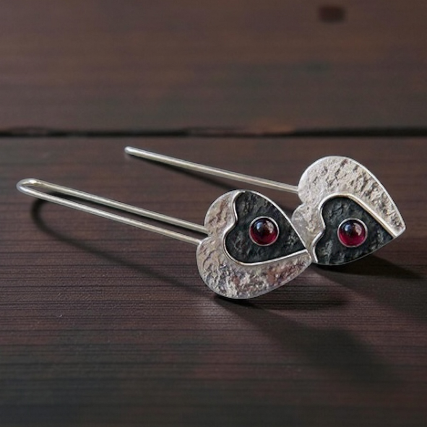 Garnet sterling silver heart earrings.