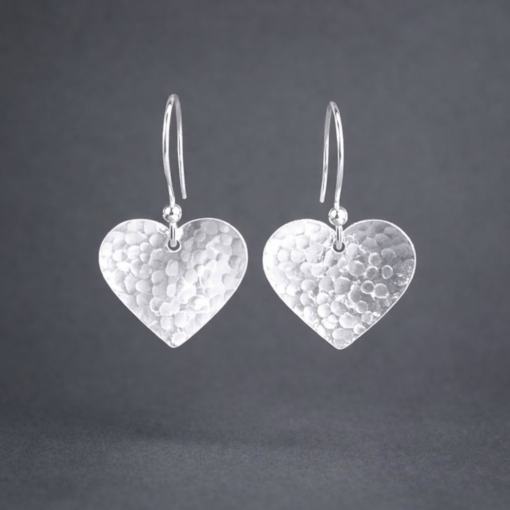 Sterling silver hammered heart dangle earrings.