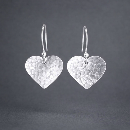 Sterling silver hammered heart dangle earrings.