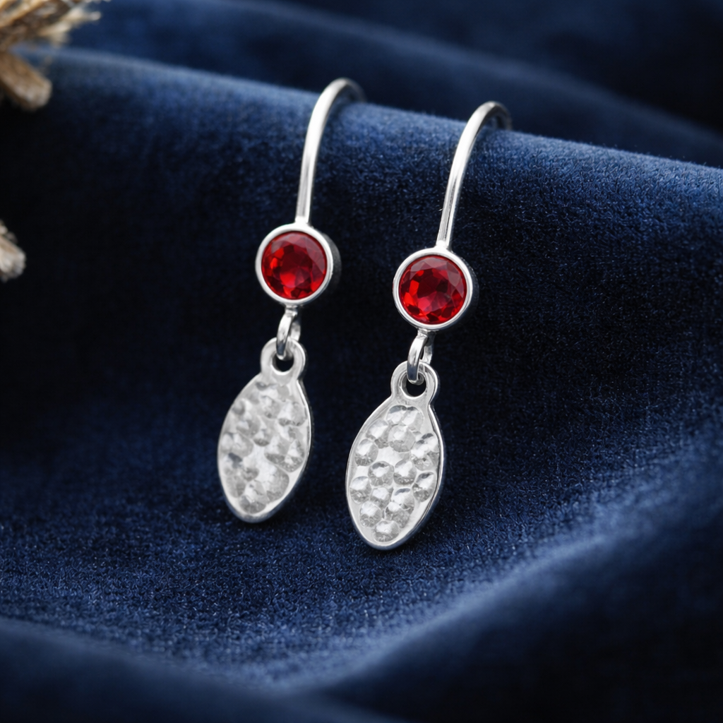 Garnet birthstone sterling silver dangle textured oval earrings.
