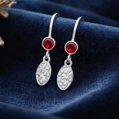 Garnet birthstone sterling silver dangle textured oval earrings.
