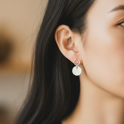 Sterling silver circle and hammered disc stud earrings.