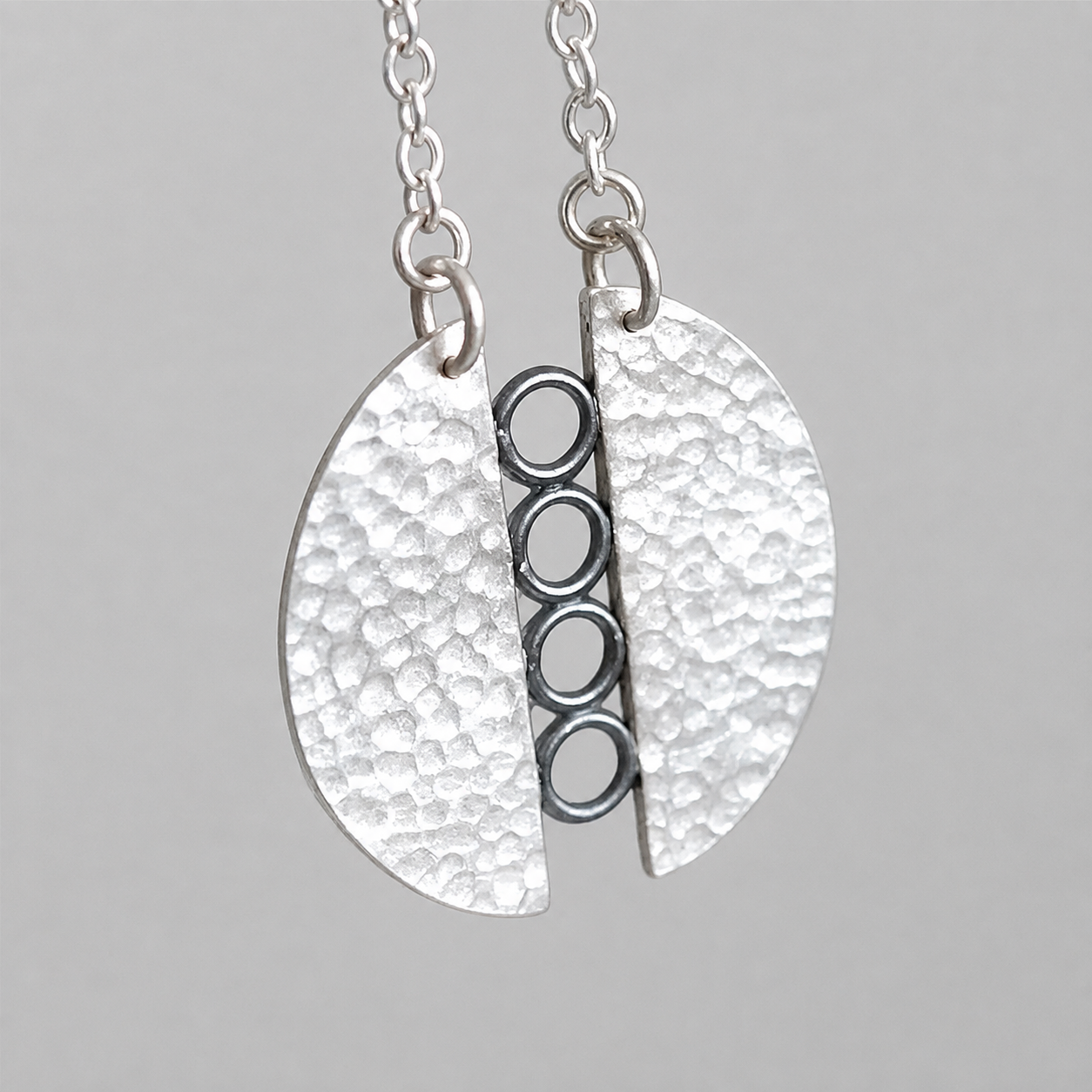 Sterling silver textured circle pendant necklace.