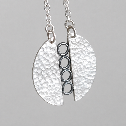 Sterling silver textured circle pendant necklace.
