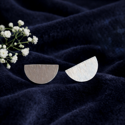Hammered semicircle sterling silver stud earrings.