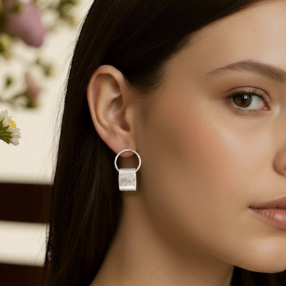 Sterling silver circle stud earrings.