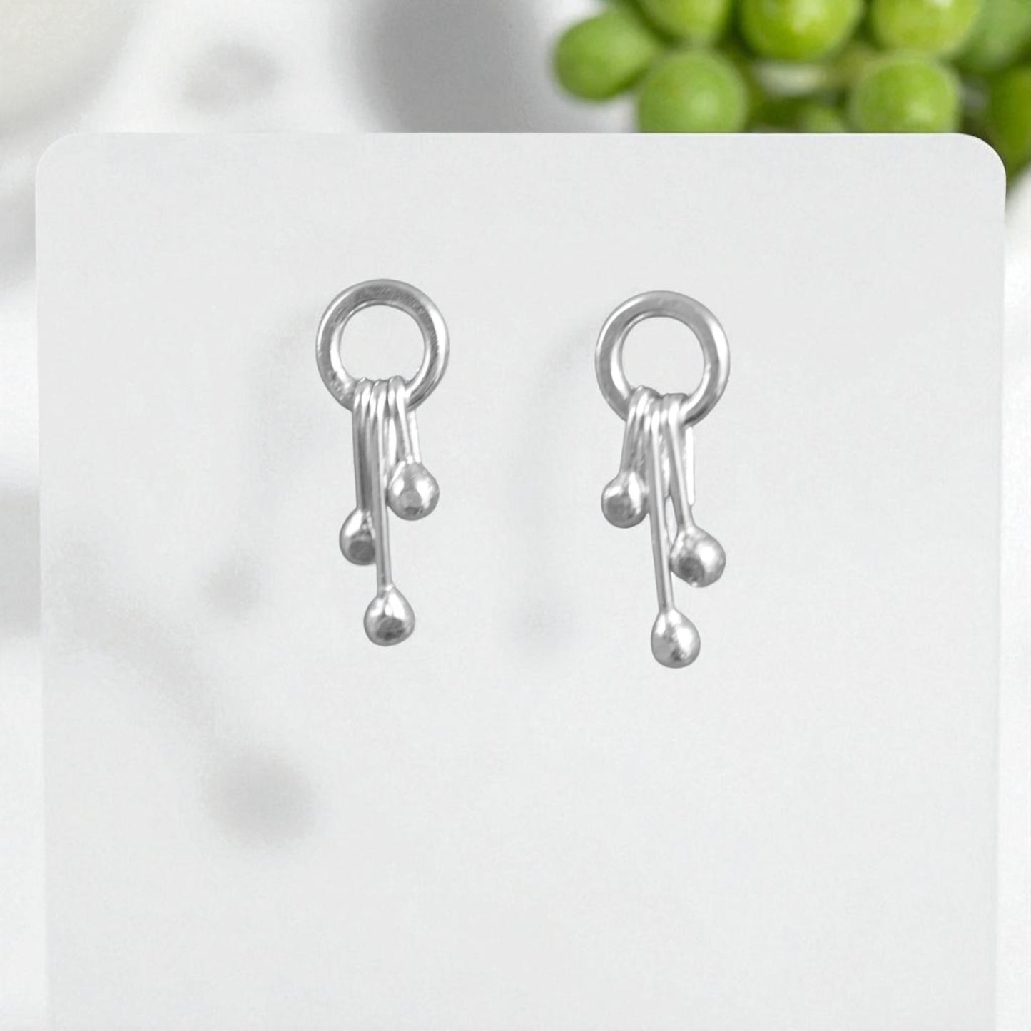 Sterling silver circle and droplets stud earrings.