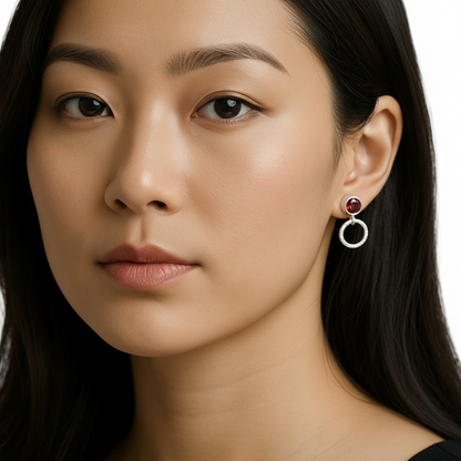 Garnet sterling silver stud earrings with a small circle.