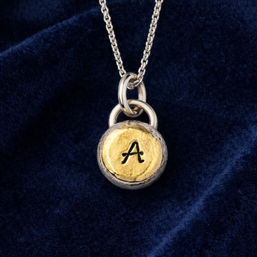 Personalised initial organic sterling silver pebble necklace.
