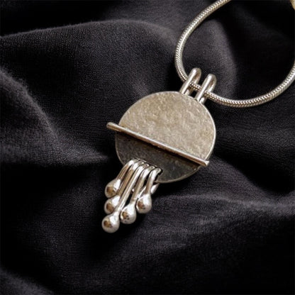 Sterling silver disc textured necklace pendant.