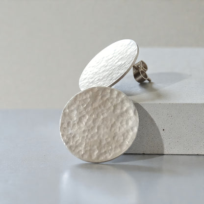 Minimalist sterling silver hammered disc stud earrings.
