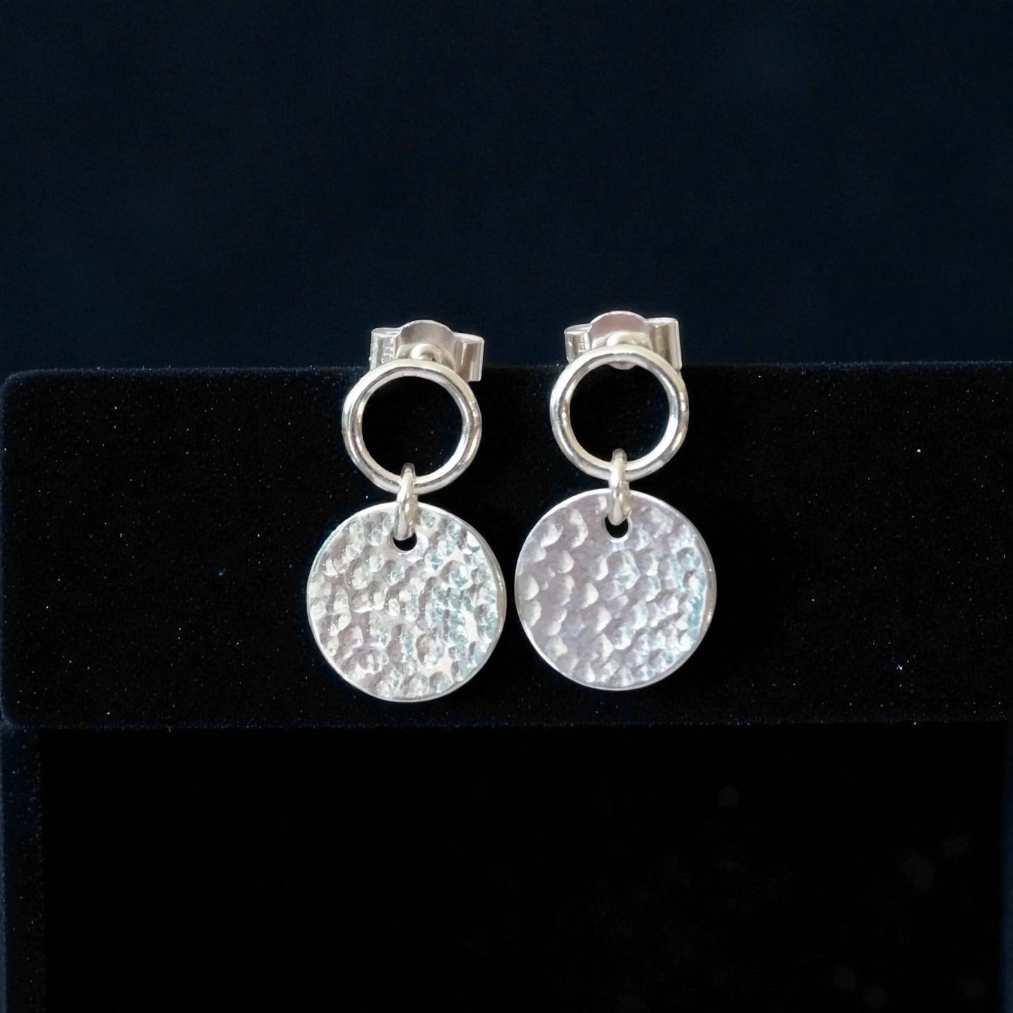 Sterling silver circle and hammered disc stud earrings.