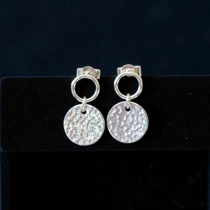 Sterling silver circle and hammered disc stud earrings.