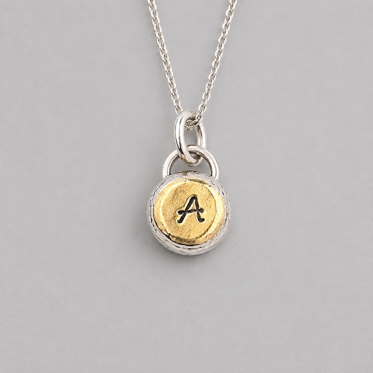Personalised initial organic sterling silver pebble necklace.