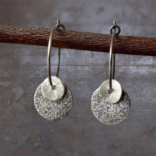 Sterling silver oxidised hammered disc hoop earrings.