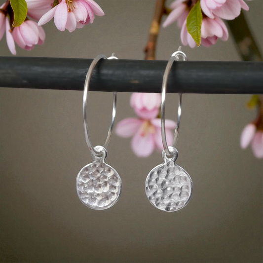 Small hammered sterling silver disc charm hoop earrings.