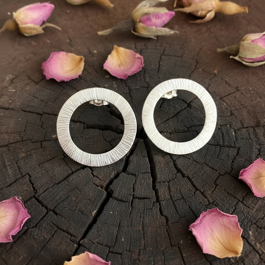 Large sterling silver circle stud earrings.