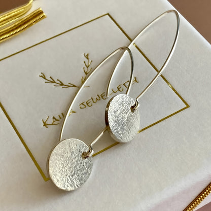 Long sterling silver hammered disc earrings