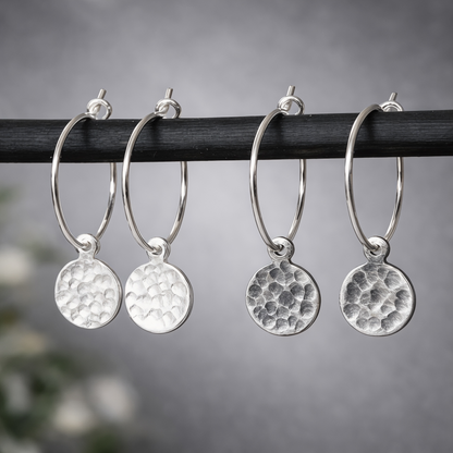 Hammered sterling silver disc charm hoop earrings.
