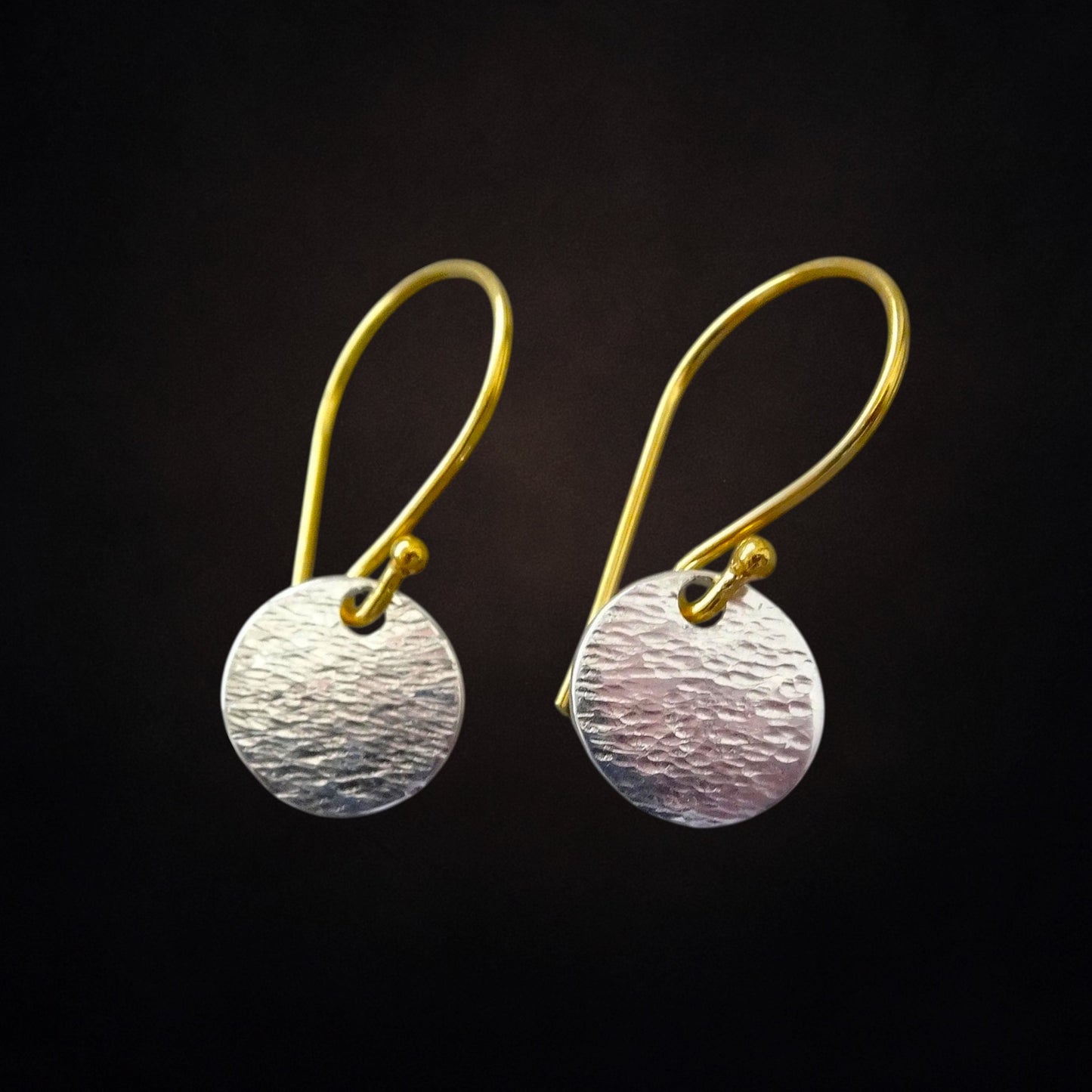 Hammered sterling silver disc and gold vermeil ear wire earrings.
