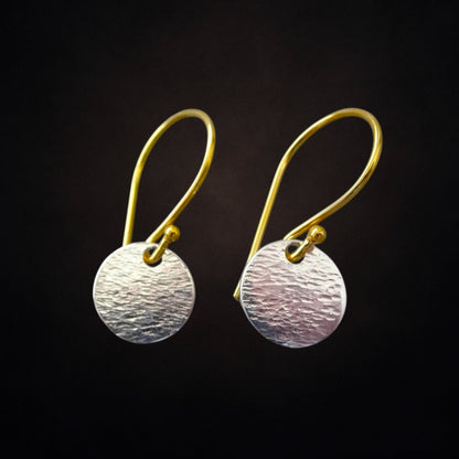 Hammered sterling silver disc and gold vermeil ear wire earrings.