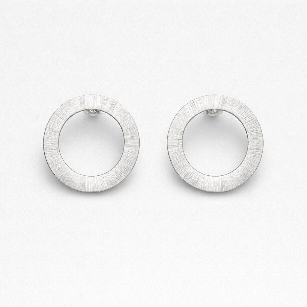 Large sterling silver circle stud earrings.