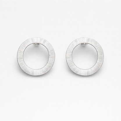 Large sterling silver circle stud earrings.
