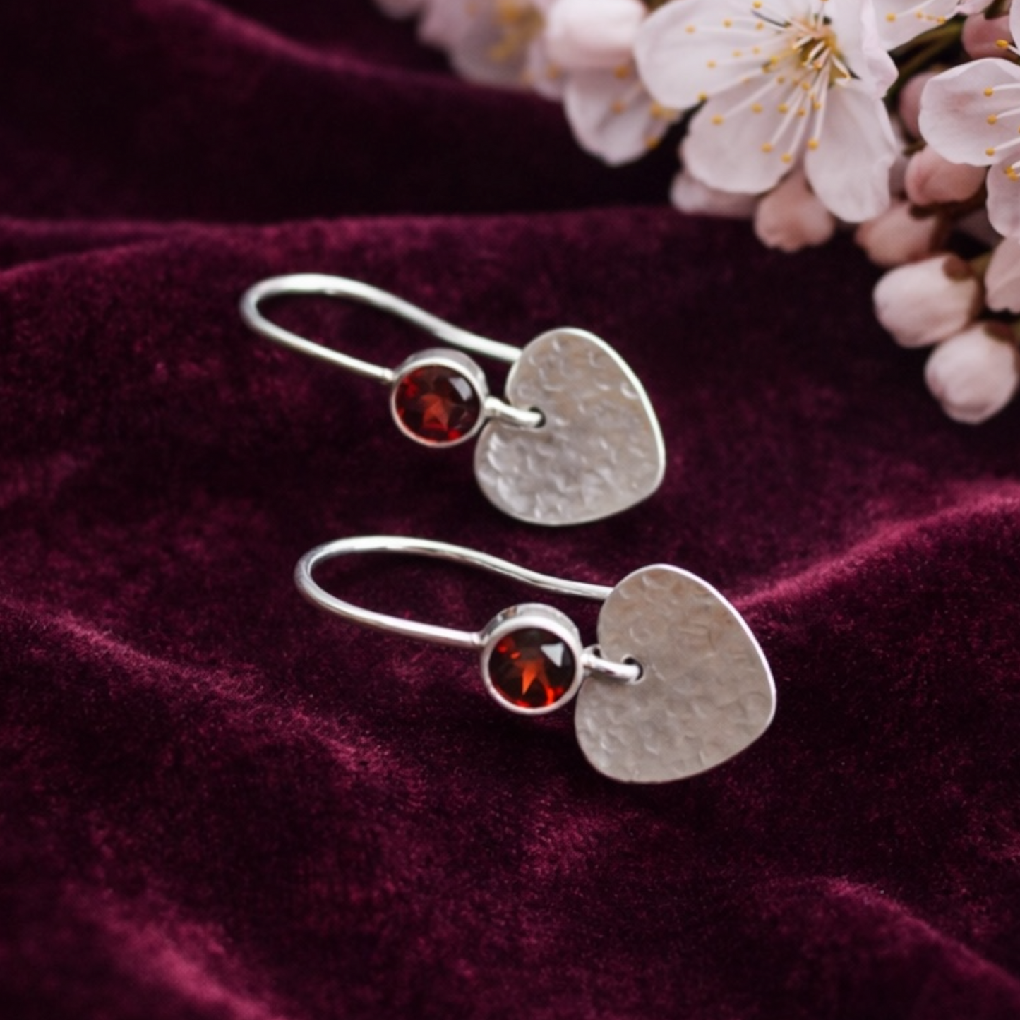 Garnet sterling silver heart dangle earrings.