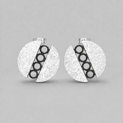 Sterling silver circle stud earrings.