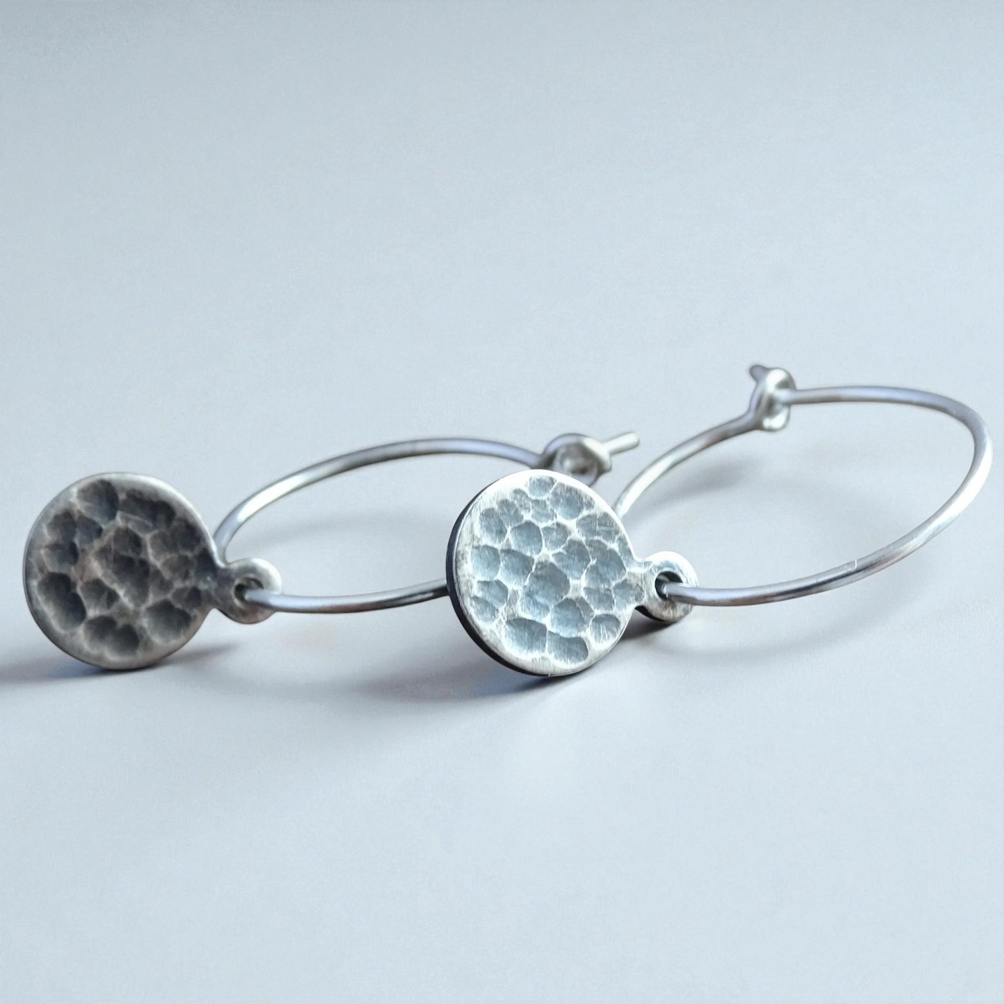 Hammered sterling silver disc charm hoop earrings.