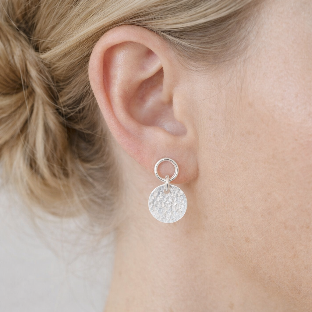 Sterling silver circle and hammered disc stud earrings.