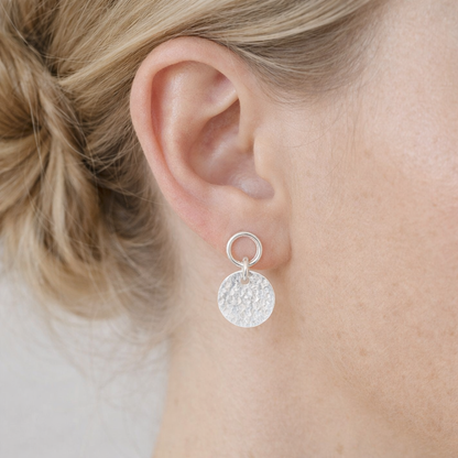 Sterling silver circle and hammered disc stud earrings.