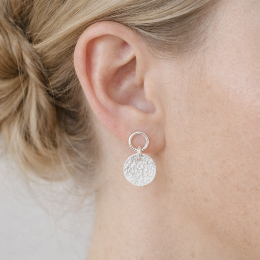 Sterling silver circle and hammered disc stud earrings.