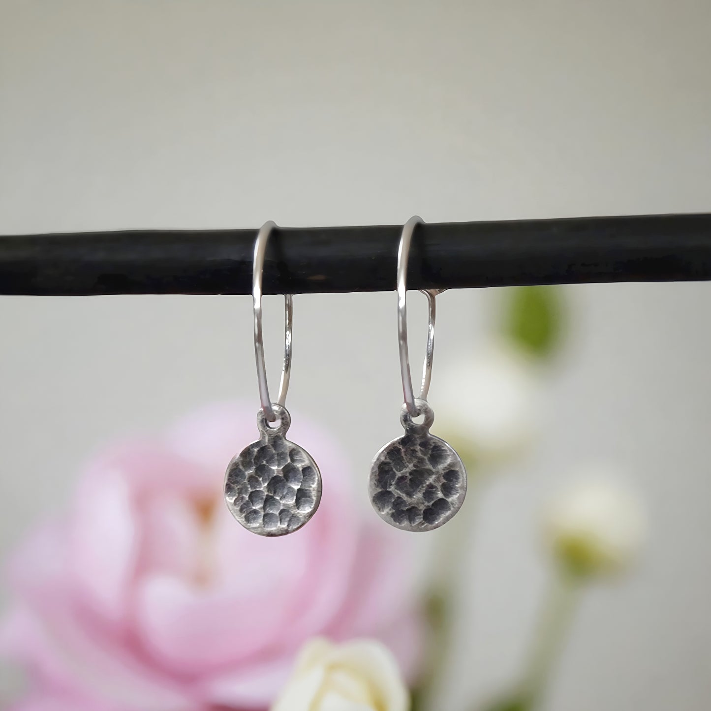Small hammered sterling silver disc charm hoop earrings.