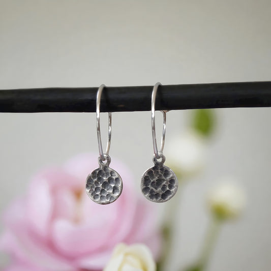 Small hammered sterling silver disc charm hoop earrings.