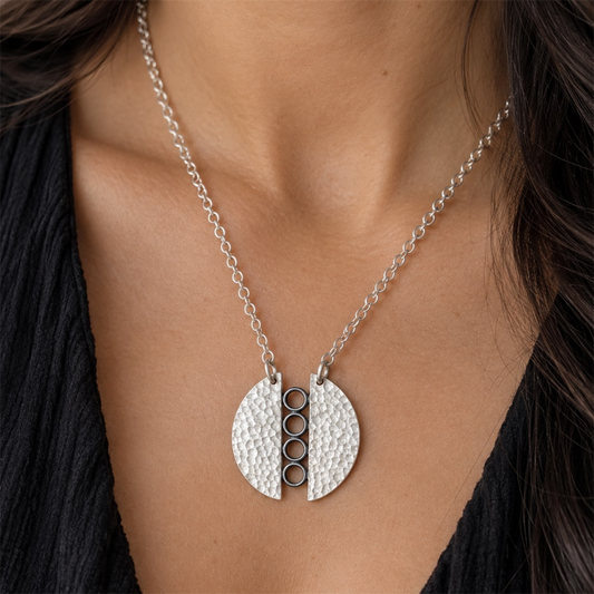 Sterling silver textured circle pendant necklace.