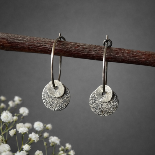 Sterling silver oxidised hammered disc hoop earrings.