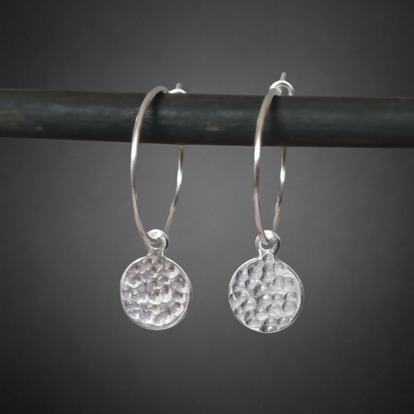 Small hammered sterling silver disc charm hoop earrings.