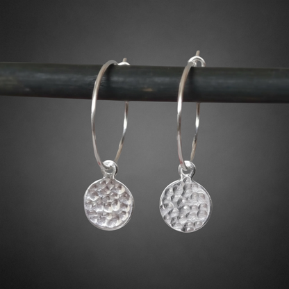 Small hammered sterling silver disc charm hoop earrings.